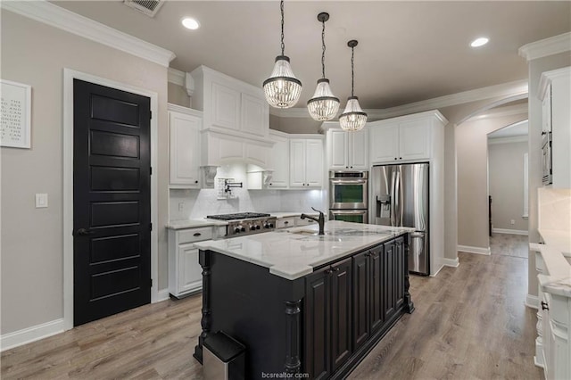 kitchen with white cabinetry, an island with sink, and appliances with stainless steel finishes