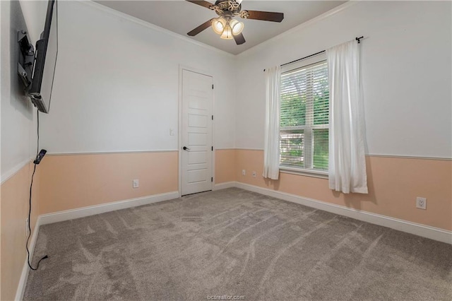 empty room with ceiling fan, light colored carpet, and ornamental molding