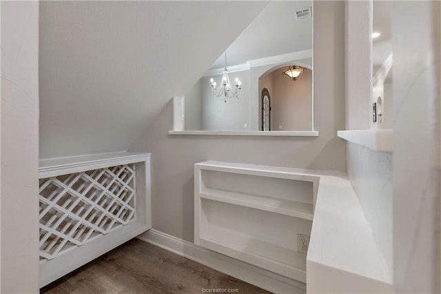 bathroom with hardwood / wood-style floors, an inviting chandelier, and lofted ceiling