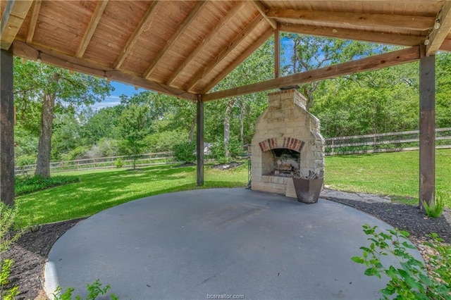 view of patio / terrace featuring an outdoor stone fireplace