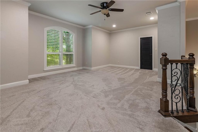 unfurnished room featuring light carpet, ceiling fan, and ornamental molding