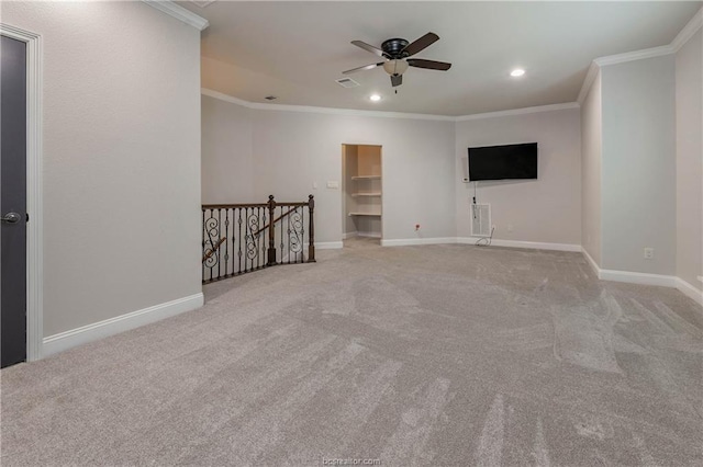 spare room with light carpet, ceiling fan, and ornamental molding