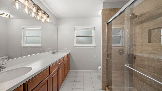 bathroom with tile patterned flooring, toilet, an enclosed shower, and vanity