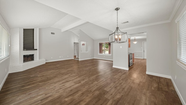 unfurnished living room featuring crown molding, vaulted ceiling with beams, a fireplace, a notable chandelier, and dark hardwood / wood-style flooring