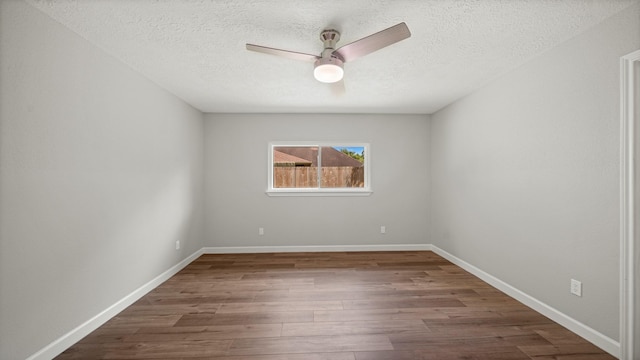 empty room with hardwood / wood-style flooring, ceiling fan, and a textured ceiling