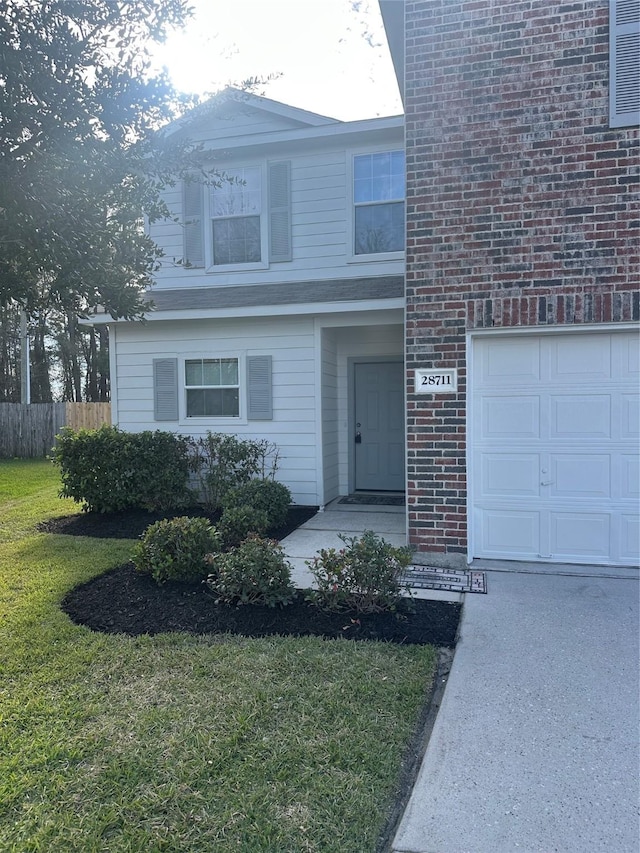 view of front facade with a front lawn and a garage