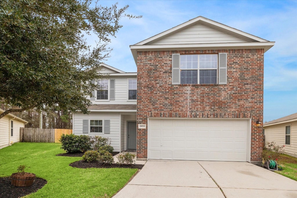 view of property featuring a front yard and a garage