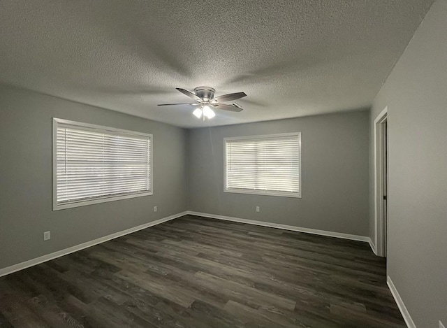 empty room featuring a textured ceiling, ceiling fan, and dark wood-type flooring