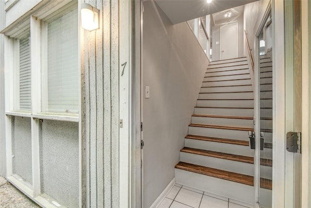 stairway featuring tile patterned flooring