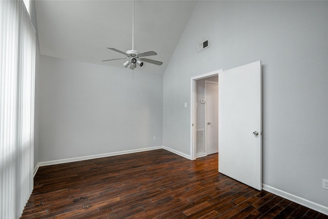 empty room with vaulted ceiling, dark wood-type flooring, and ceiling fan