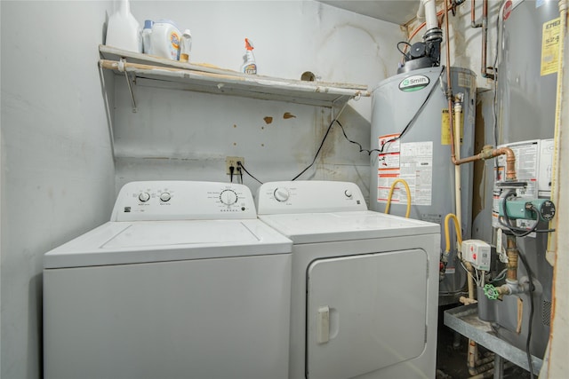 clothes washing area with washer and clothes dryer and gas water heater