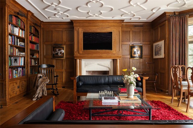 sitting room with wooden walls and hardwood / wood-style flooring