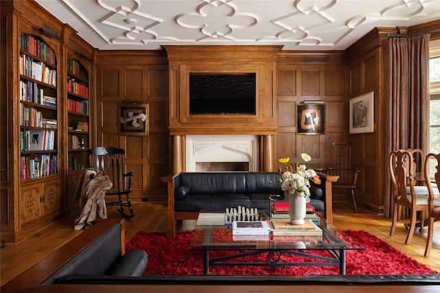 living area with wooden walls and wood-type flooring