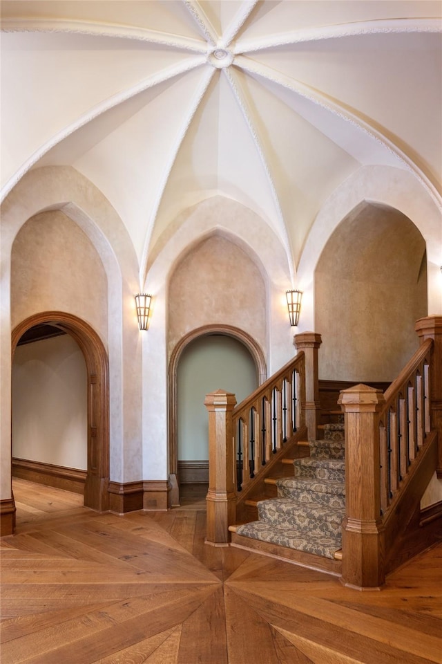 interior space featuring parquet floors and lofted ceiling