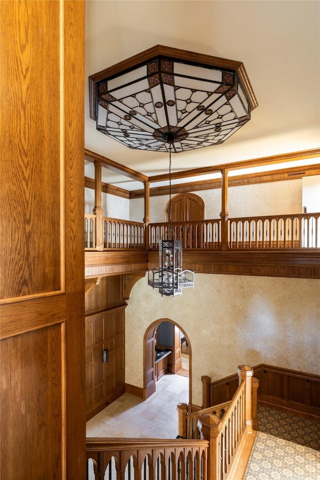 staircase featuring an inviting chandelier