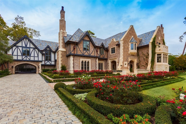 english style home featuring a front lawn