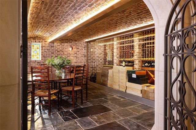 wine cellar featuring brick ceiling and brick wall