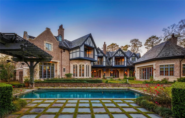 back of house with a balcony and a pergola