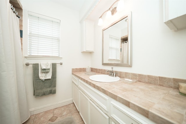 bathroom with tile patterned flooring and vanity