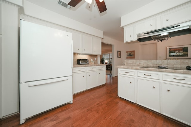 kitchen with ceiling fan, tasteful backsplash, hardwood / wood-style floors, white fridge, and white cabinets