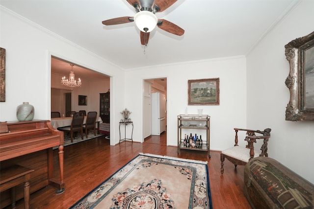 sitting room featuring crown molding, ceiling fan with notable chandelier, and dark hardwood / wood-style floors