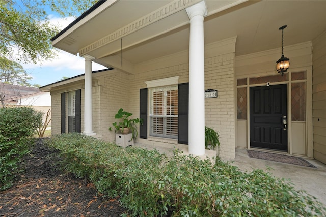 view of exterior entry with covered porch