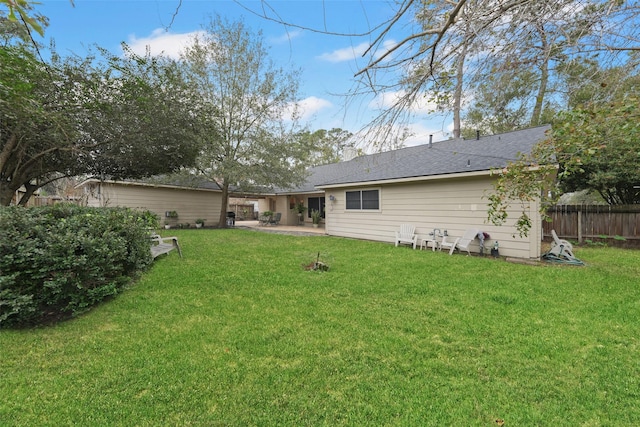 back of property with a patio area and a yard