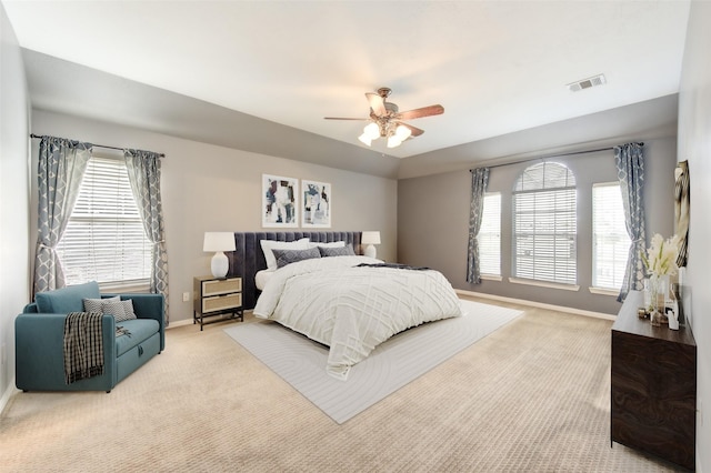 bedroom with ceiling fan and light carpet