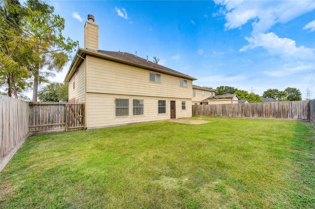 rear view of house featuring a patio area and a yard