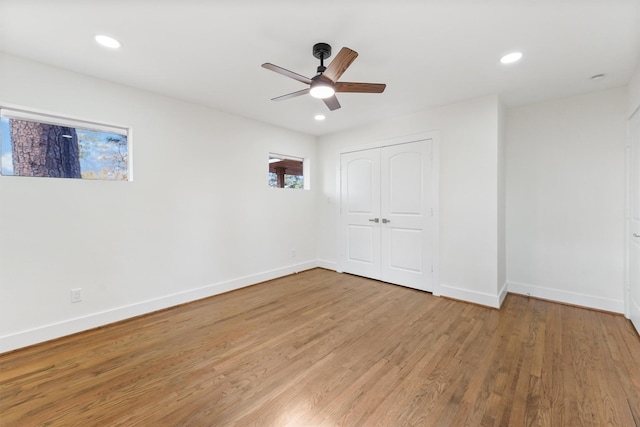 empty room with ceiling fan and light wood-type flooring