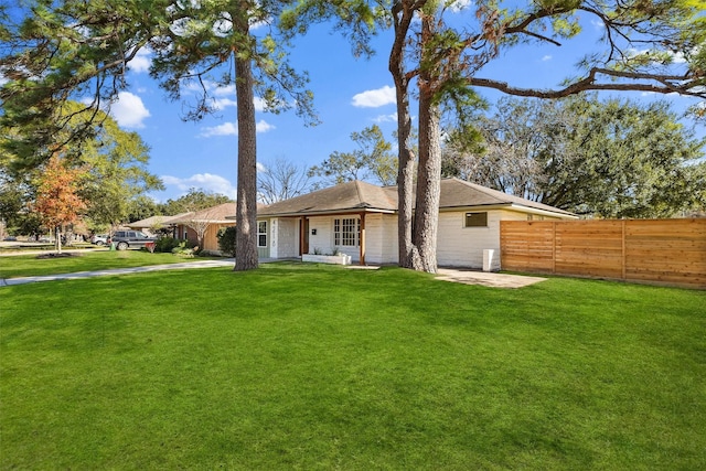 view of front of house with a patio and a front lawn