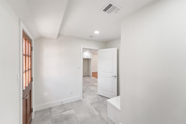 unfurnished room featuring vaulted ceiling