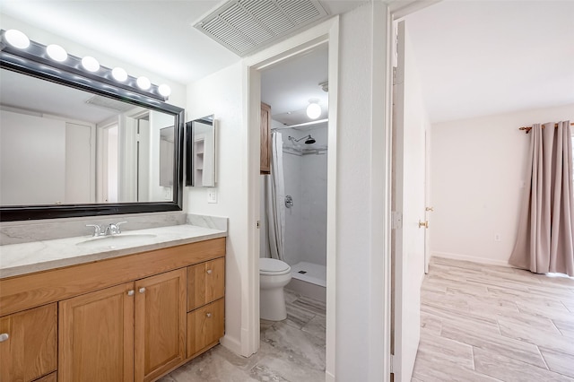 bathroom with vanity, toilet, and walk in shower