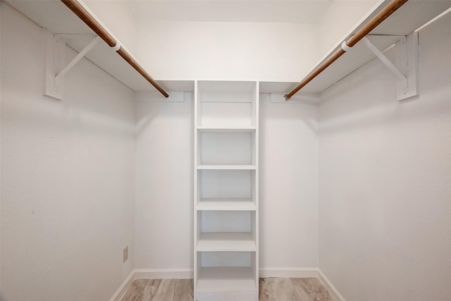 spacious closet with light hardwood / wood-style floors