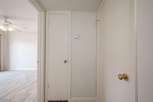 corridor with light hardwood / wood-style floors