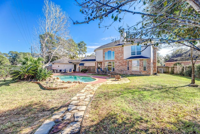 back of property featuring a lawn, a patio area, and a fenced in pool