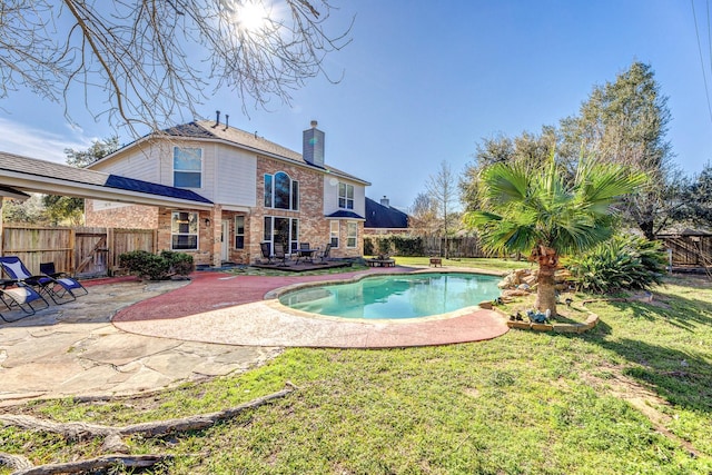 view of pool with a yard and a patio