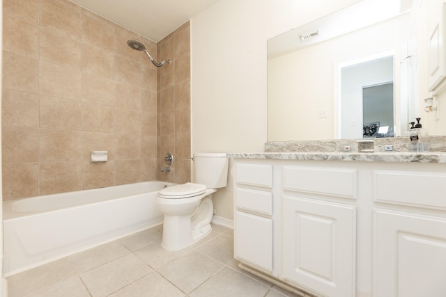 full bathroom with tile patterned flooring, vanity, toilet, and tiled shower / bath