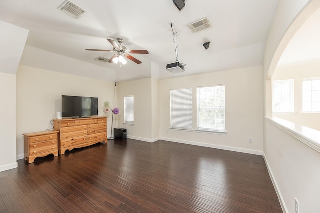 living room featuring dark wood-type flooring, a wealth of natural light, and vaulted ceiling