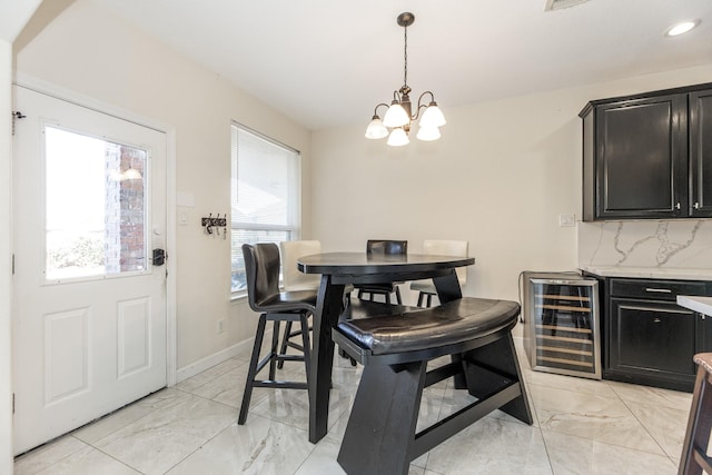 dining room with a notable chandelier, plenty of natural light, and wine cooler