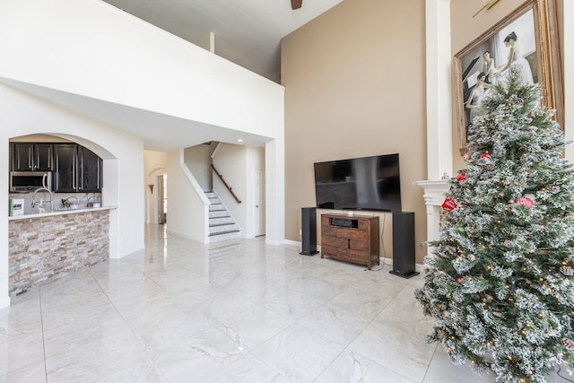 living room featuring a towering ceiling