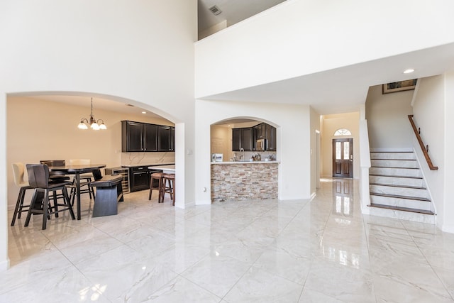 living room featuring a high ceiling and a chandelier