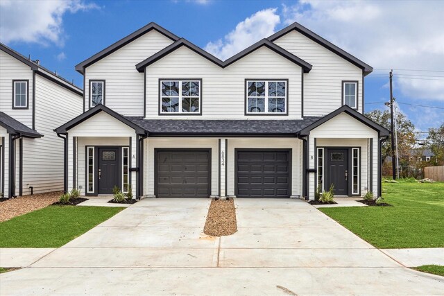 view of front of property featuring a garage and a front yard