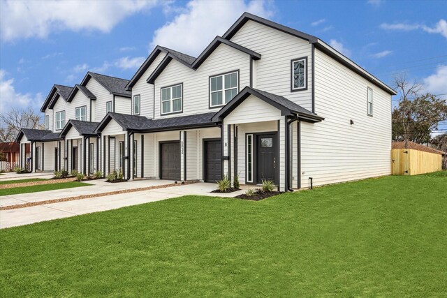 view of front of home with a garage and a front yard