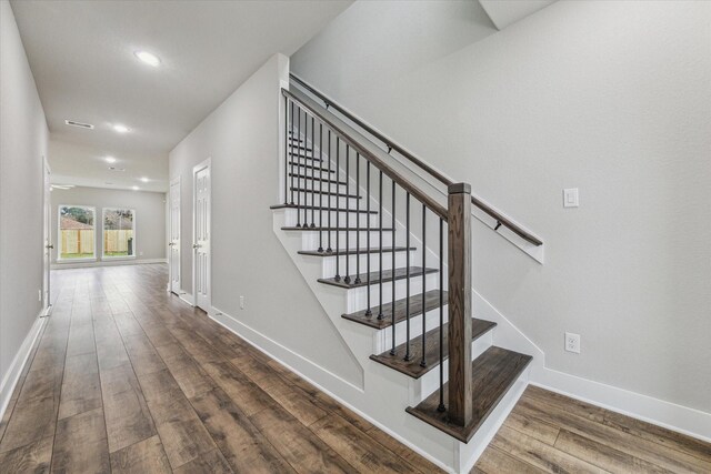 staircase featuring hardwood / wood-style flooring