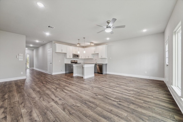 unfurnished living room with ceiling fan and hardwood / wood-style floors