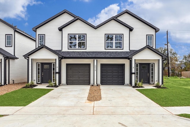 view of front of house featuring a garage and a front lawn