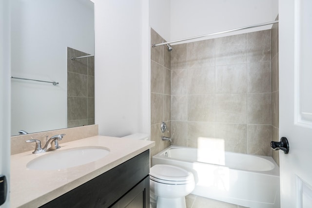 full bathroom with toilet, vanity, and tiled shower / bath