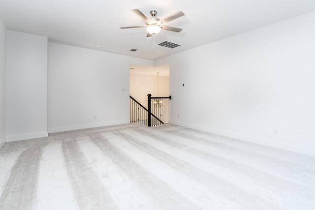 spare room featuring ceiling fan and light carpet