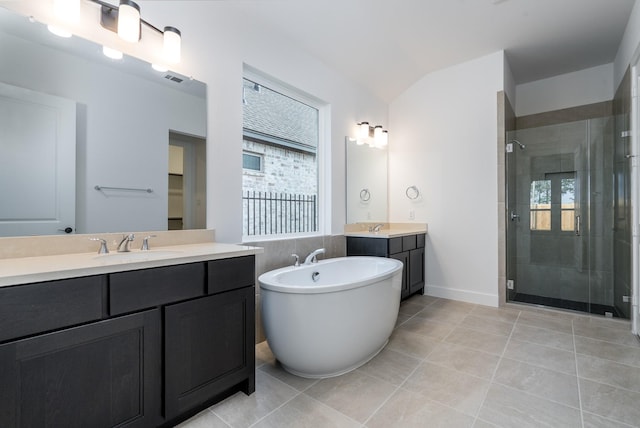 bathroom featuring tile patterned floors, vanity, lofted ceiling, and shower with separate bathtub